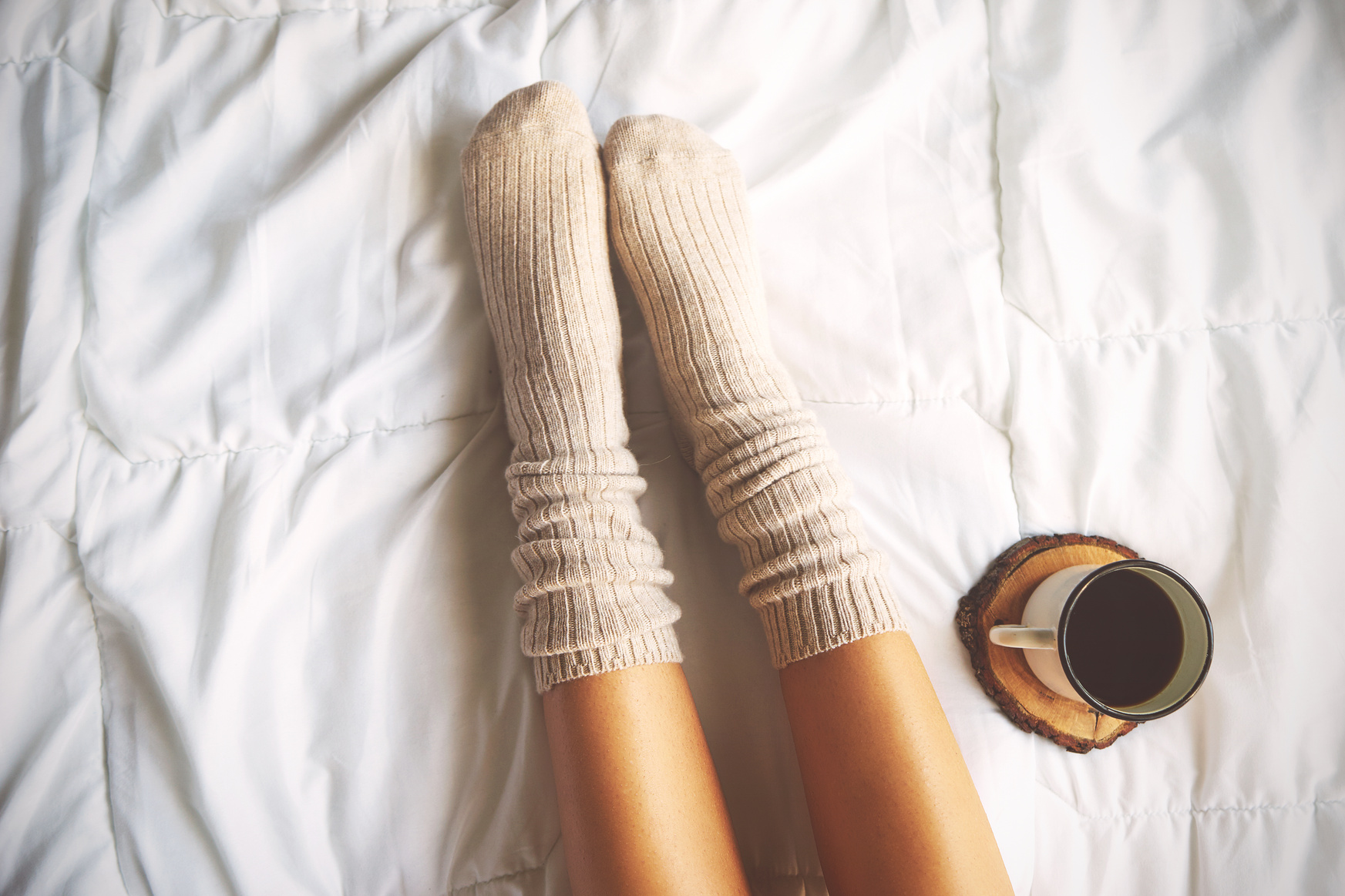 Legs on Bed with  Coffee